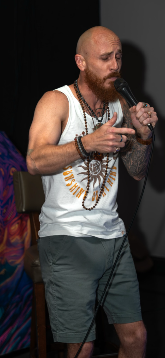 Derek performing on the microphone