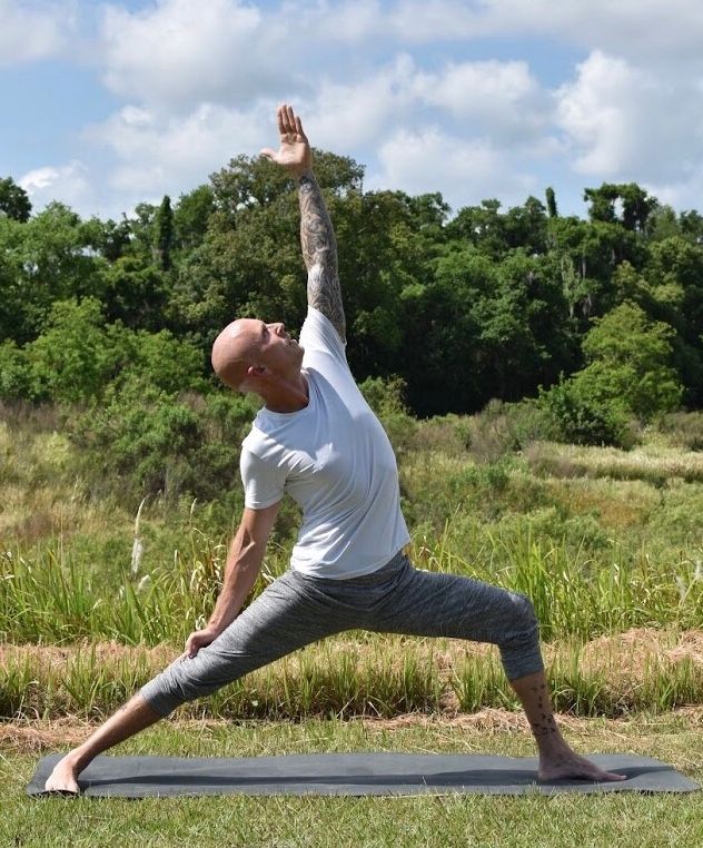 GRMSLY practising movement outdoors on a mat in open grassland